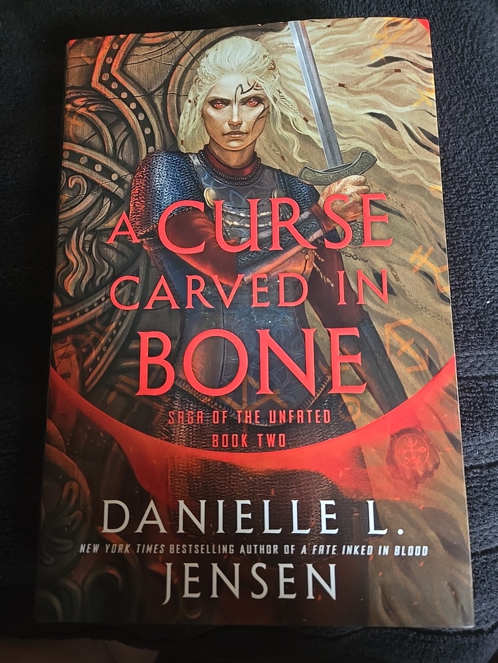 A Curse Carved in Bone by Danielle L. Jensen - Red & Gold Fantasy Hardcover